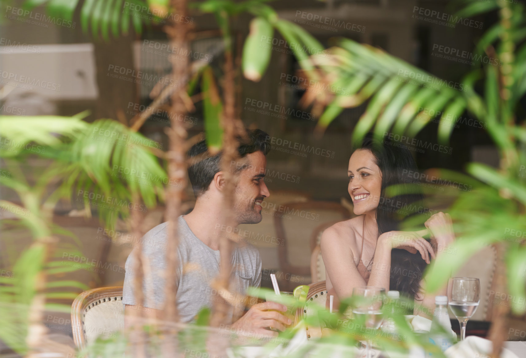 Buy stock photo Happy couple, restaurant and date with romance for meal, dinner or enjoying anniversary at hotel. Man and woman with smile for dining, eating or romantic hospitality at lodge or indoor accommodation