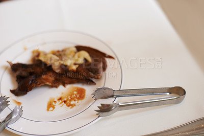 Buy stock photo Fine dining, meat and food on plate in restaurant for nutrition, dinner or lunch at table with tongs. Protein, steak and healthy meal at social event, cuisine and celebration in cafe, diner or supper