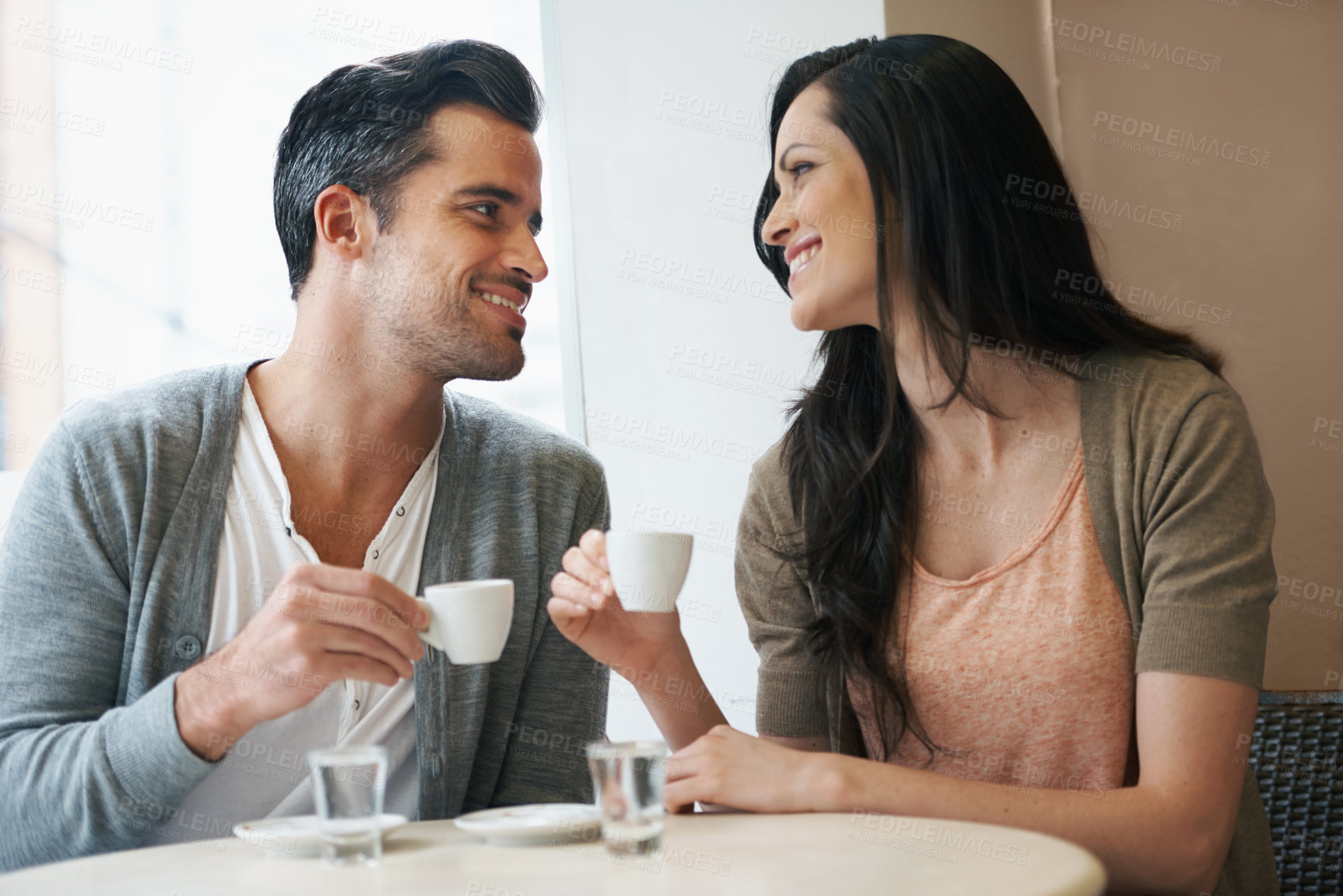 Buy stock photo Date, coffee and couple at cafe with relax, smile and together with love and hot drink at a table. Espresso, morning and happy marriage at a restaurant with bonding, care and romance at bistro