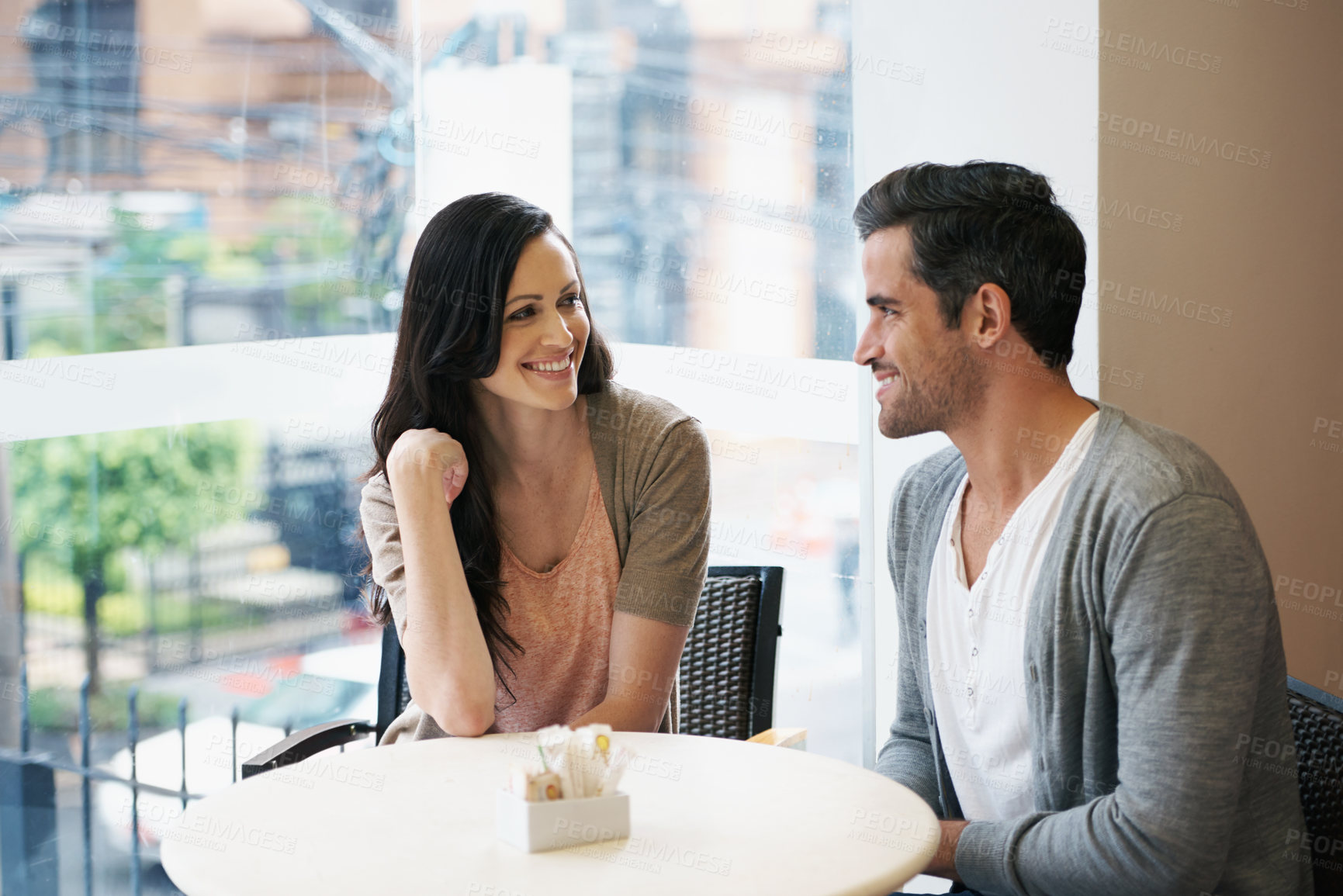 Buy stock photo Happy couple, dating and relaxing at coffee shop, restaurant and cafe for bonding, connection and love. People, lovers and romantic at table for conversation, relationship and talking with smile