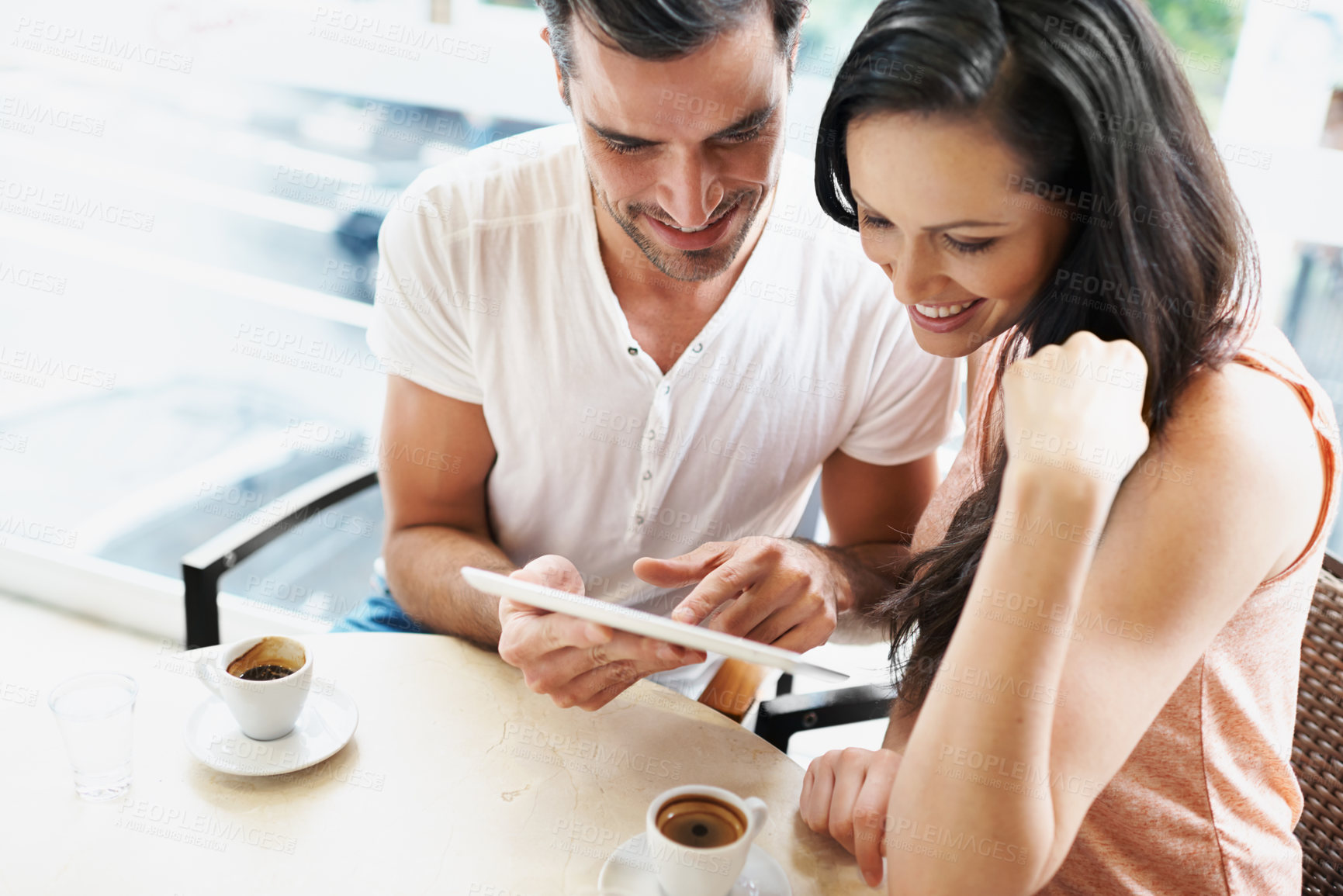 Buy stock photo Happy, couple and tablet with coffee for search, browsing and bonding together in Rio de Janeiro. Boyfriend, girlfriend and touch screen for online, social media or typing with romance at cafe