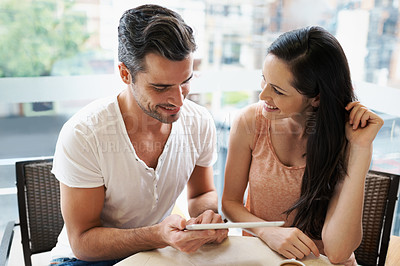 Buy stock photo Happy couple, love and tablet in coffee shop for bonding with social media and relax on holiday together to post. Man, woman or touchscreen to scroll online menu in restaurant or connection for meme