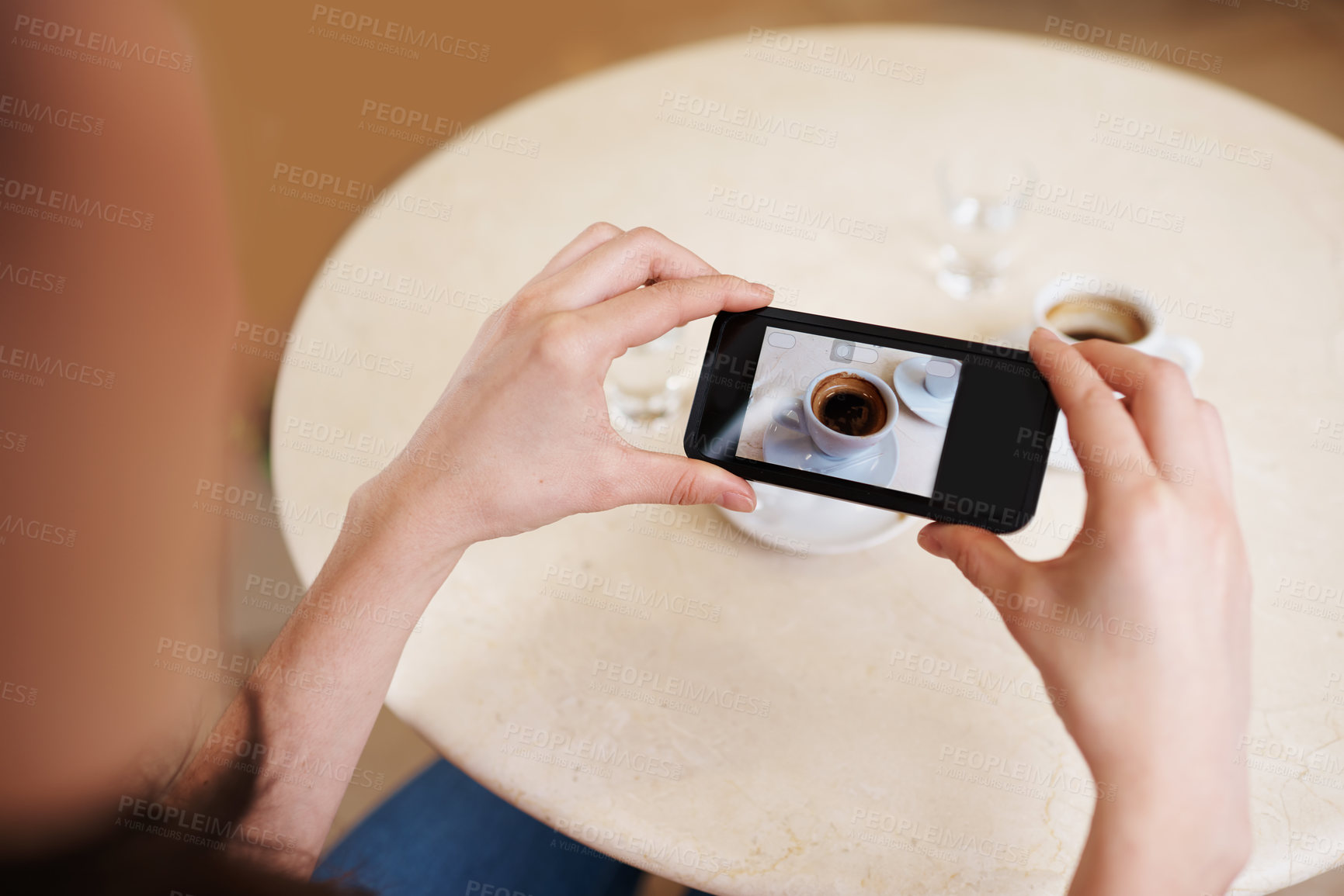 Buy stock photo Hands, smartphone screen and top view photography of coffee, tea or espresso for social media, content or blogging. Closeup, person and cellphone with hot beverage cup at restaurant, cafe and table
