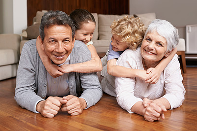 Buy stock photo Floor, piggyback or portrait of grandparents with happy kids playing or hugging with love in family home. Elderly grandma or fun old man relaxing or bonding to enjoy time with children in retirement 