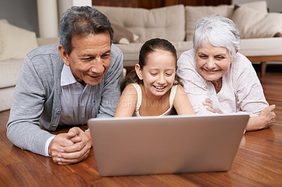 Buy stock photo Laptop, floor or grandparents with girl for movie streaming online subscription in retirement at home together. Child, relaxing or happy grandmother loves watching fun videos with a senior old man 