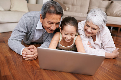 Buy stock photo Laptop, floor or grandparents with happy child for movie streaming online subscription in retirement at home. Girl, relaxing together or grandmother watching videos on internet with a senior old man