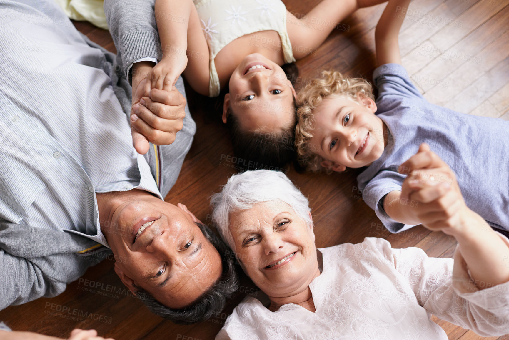 Buy stock photo Portrait, holding hands or grandparents on the floor with happy kids smiling together in family home. Grandma in retirement, relax or fun children siblings bonding to enjoy quality time with old man 