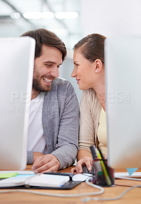 Buy stock photo Shot of a two young business people gazing affectionately at each other