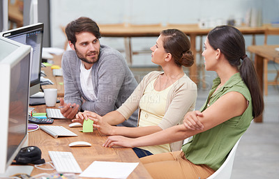 Buy stock photo Creative, coworking space and man with women at desk for conversation, brainstorming and digital marketing. Computer, office and teamwork at online advertising agency with discussion for planning.