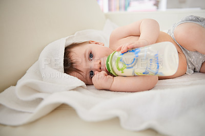 Buy stock photo Baby, bottle and relax with boy, calm and nutrition with wellness and childcare with blanket. Home, kid and newborn  drinking milk with growth and development with peace and joyful with formula
