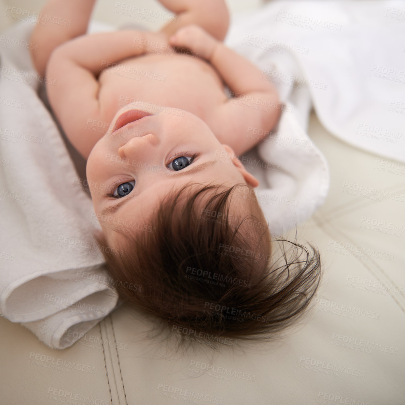 Buy stock photo Baby boy, healthy and relaxing on blanket for comfort, care and infant development at home. Adorable child, growth and lying on bed rest in house, childhood and newborn with blue eyes and hair