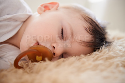 Buy stock photo Baby, sleeping and pacifier with relax in home for healthy development, growth and tired in bedroom. Child, rest and dummy in mouth with nap, dreaming and wellness in nursery of house or apartment