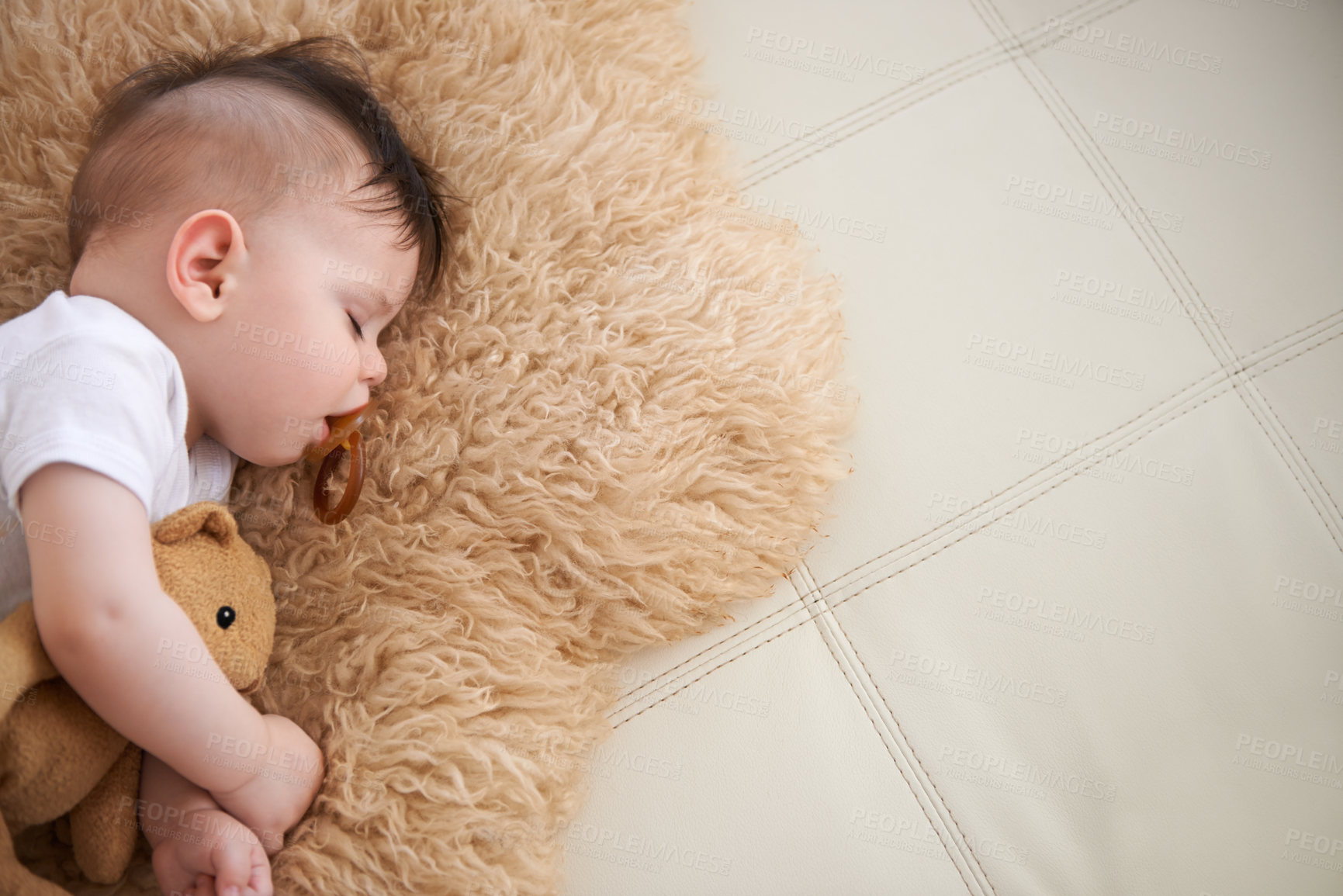 Buy stock photo Baby, sleep and cuddle with teddybear on couch at home, rest and relax with dummy and dream. High angle, toddler,  and nap in sofa for child development, growth and innocent with peace for bedtime.