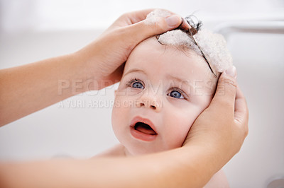 Buy stock photo Cropped shot of a mother washing her baby boy's hair