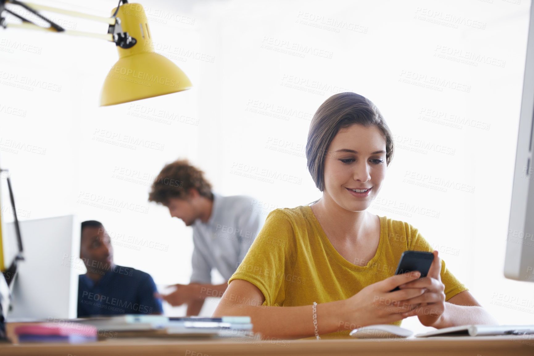 Buy stock photo Woman, smartphone and online at desk, smiling at device for notification.Digital, technical career and creative web design with happy employee, scrolling and browsing internet on social media 

