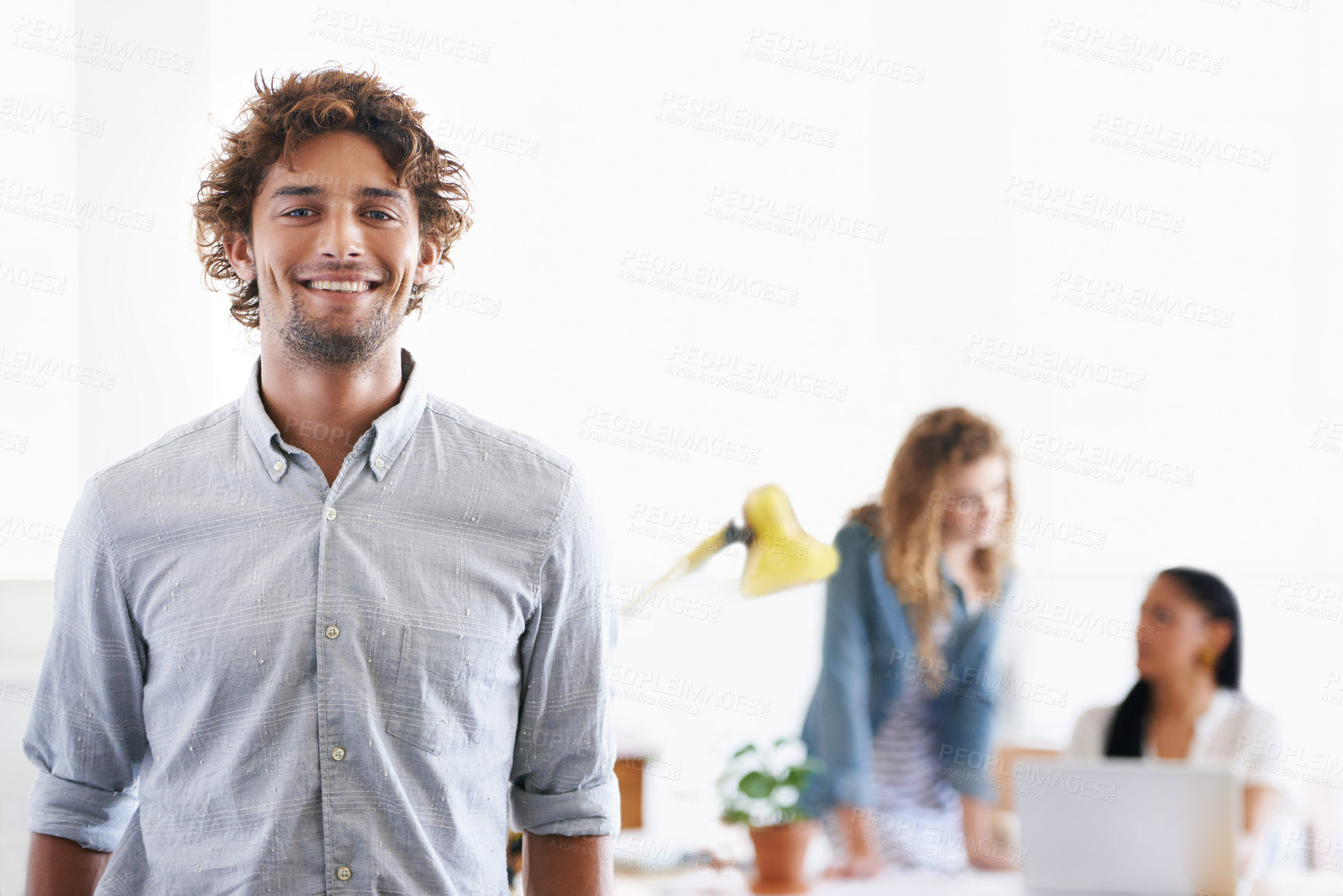 Buy stock photo Portrait of a young office professional with his colleagues in the background