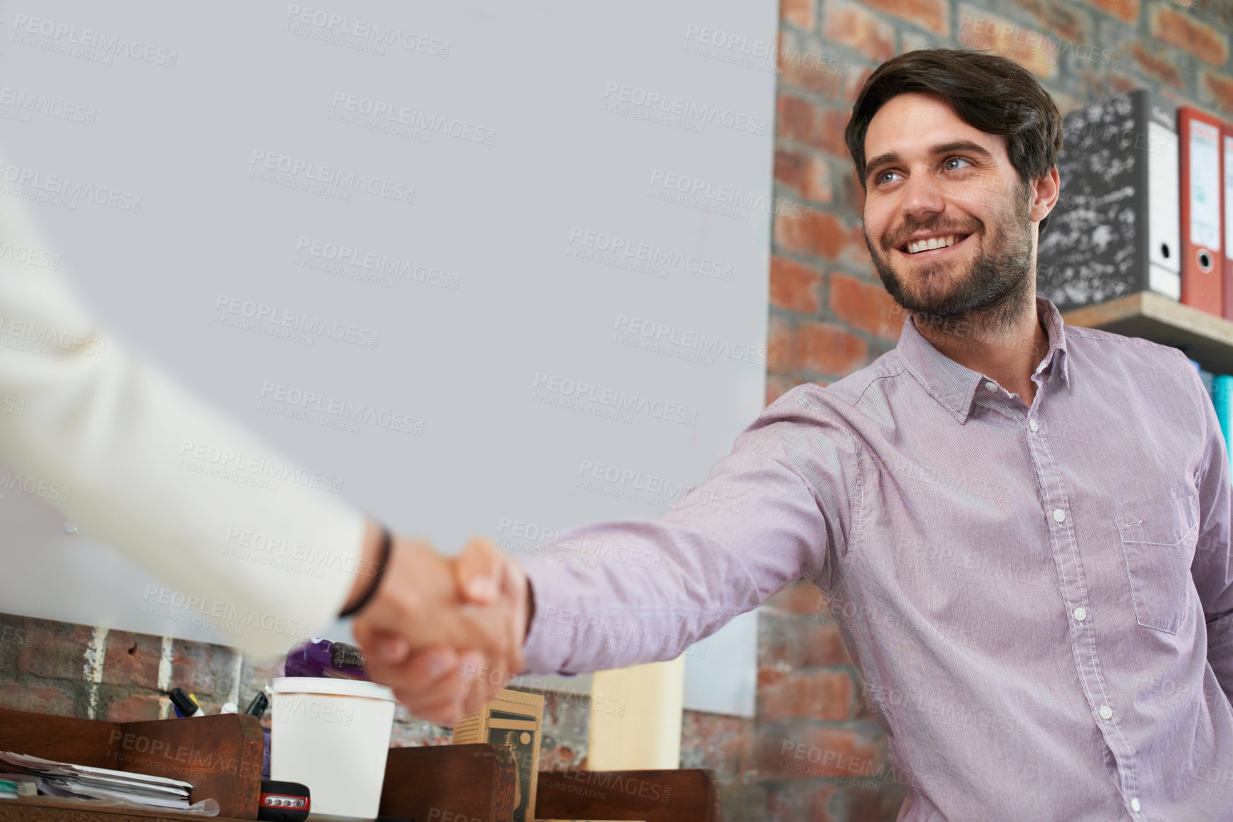 Buy stock photo A young business man shaking hands with someone