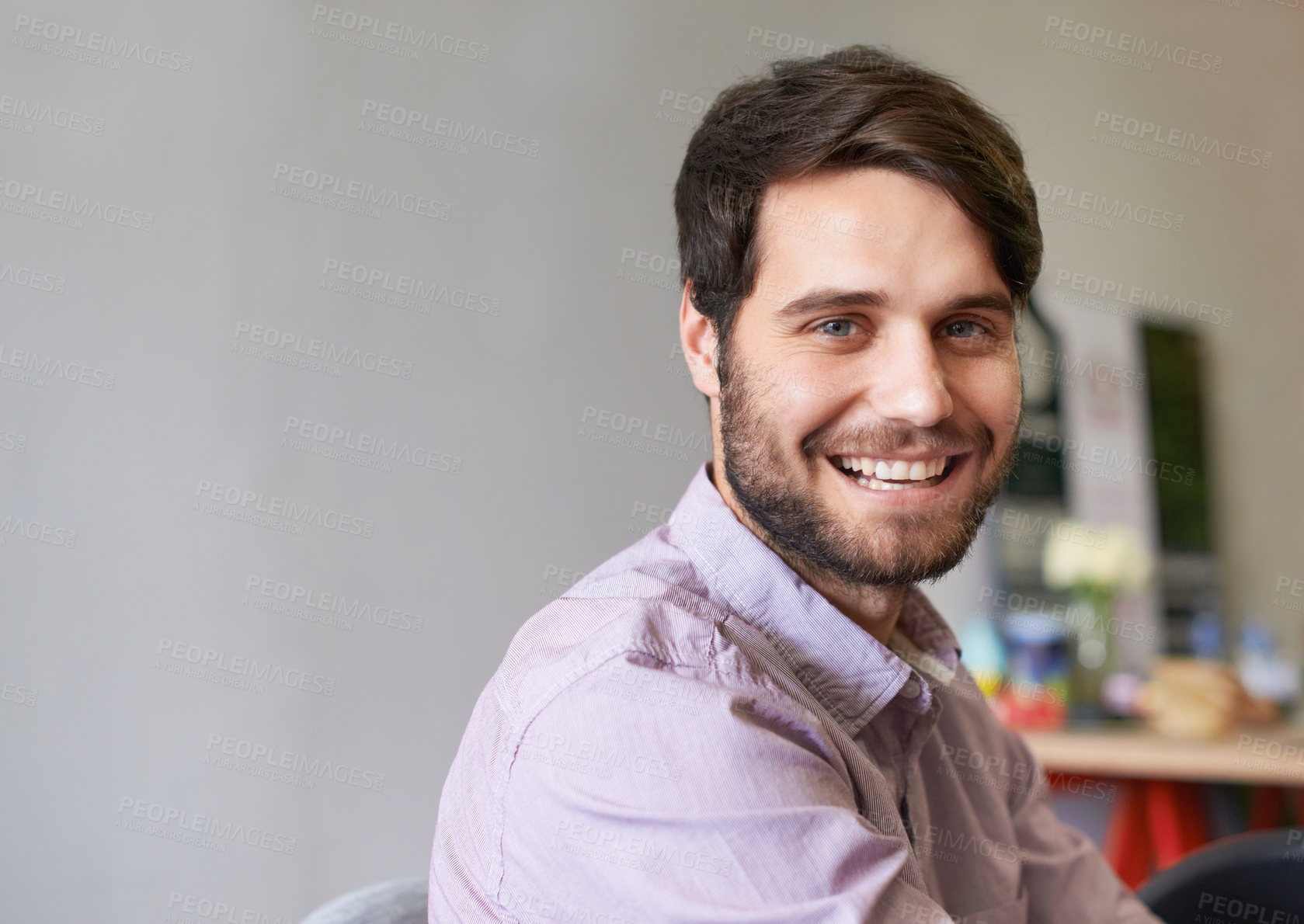 Buy stock photo A handsome young businessman smiling at the camera