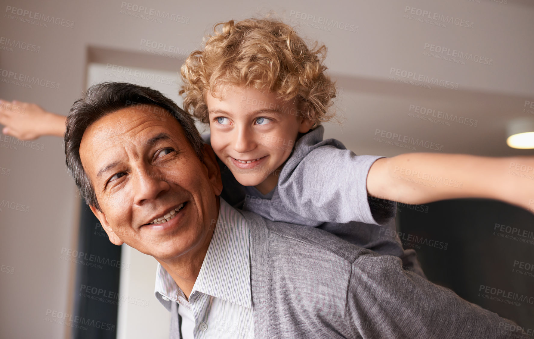 Buy stock photo A grandfather giving his grandson a piggyback ride