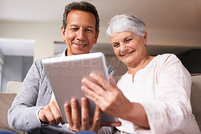 Buy stock photo A senior couple using a digital at home