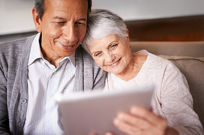 Buy stock photo Senior, couple and hug with tablet on sofa for online bingo, crossword puzzle or internet games with smile. Elderly, man and woman with face, happiness or embrace with technology for web news in home