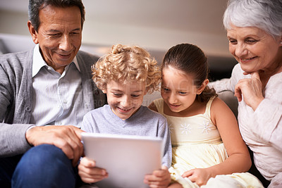 Buy stock photo Happy family, grandparents and kids with tablet on sofa for entertainment or social media at home. Grandma, grandpa and children with smile, hug and love on technology for bonding or game at house