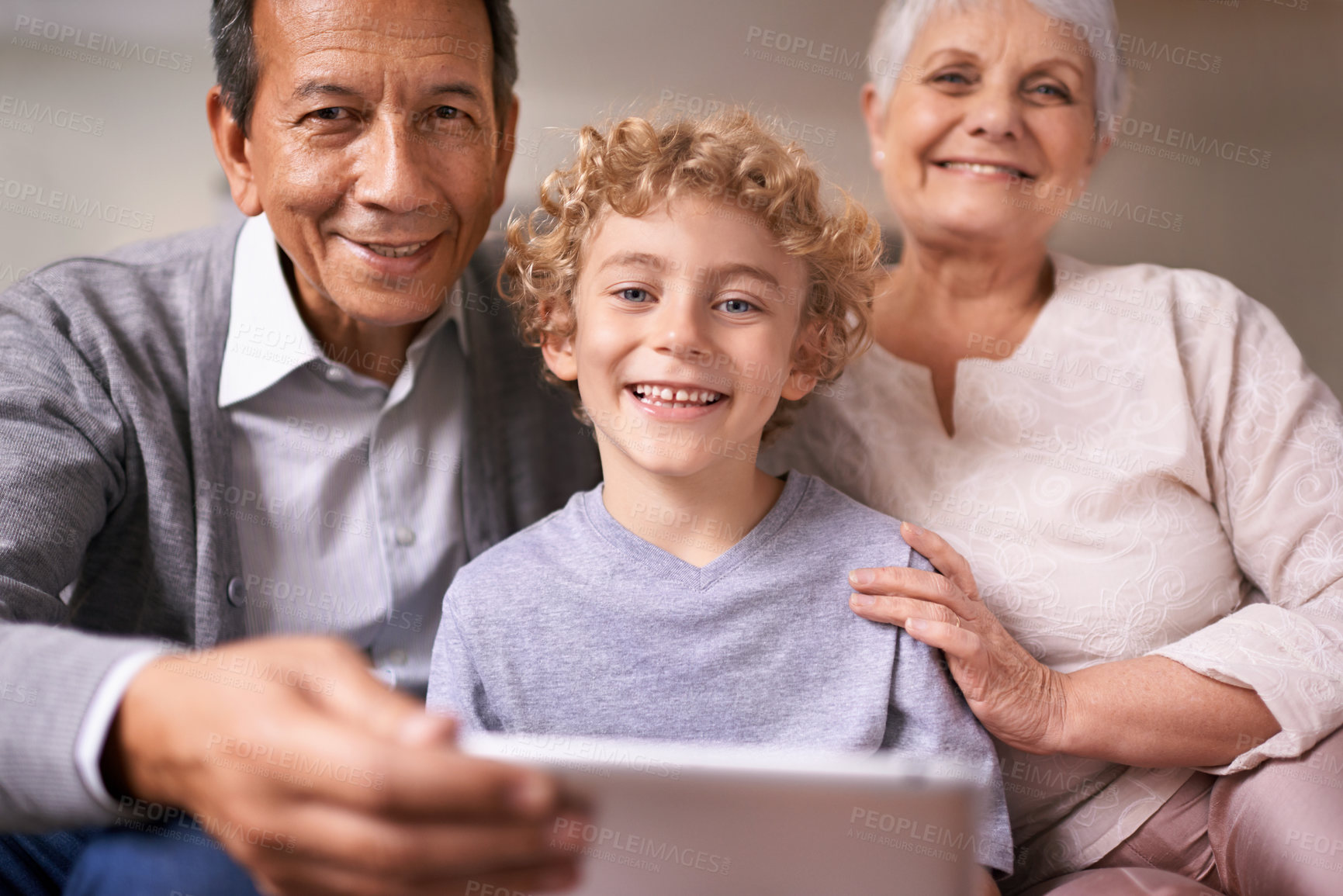 Buy stock photo Happy family, portrait and grandparents with child on tablet for entertainment, social media or research on sofa at home. Grandma, grandpa and kid smile with technology for online connection at house