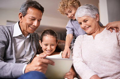 Buy stock photo Happy family, grandparents and kids with tablet for social media, entertainment or research on sofa at home. Grandma, grandpa and young children smile on technology for online show or movie at house