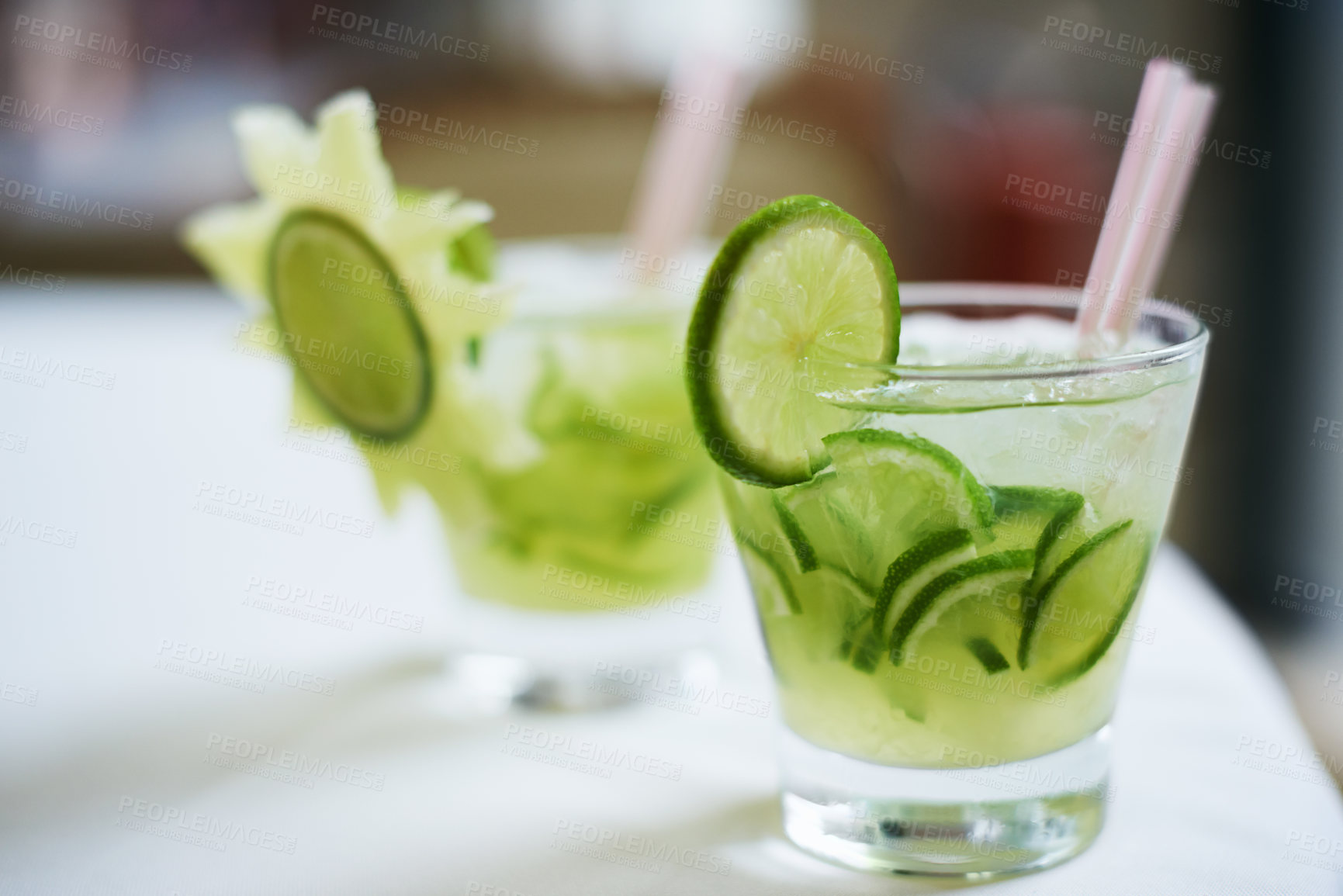Buy stock photo Cocktail, alcohol and glass with fruit for mojito drink on table for party, club and bar. Mockup, background and closeup of mocktail, beverage and liquid with lime, ice and liquor for celebration