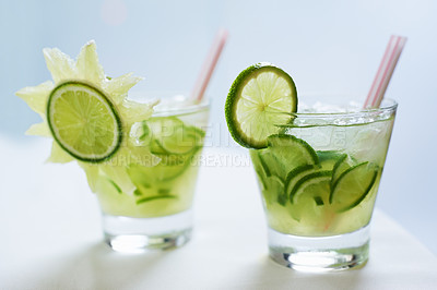 Buy stock photo Cocktail, alcohol and mojito with lime for drink on table for party, club and bar or restaurant. Glass, background and closeup of mocktail, beverage and liquid with fruit, ice and liquor for drinking