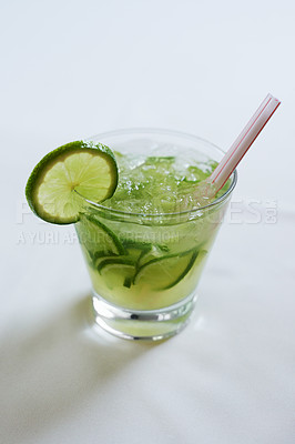Buy stock photo Cocktail, alcohol and glass with lime for mojito drink on table for party, club and bar. Mockup, background and closeup of mocktail, beverage and liquid with fruit, ice and liquor for celebration