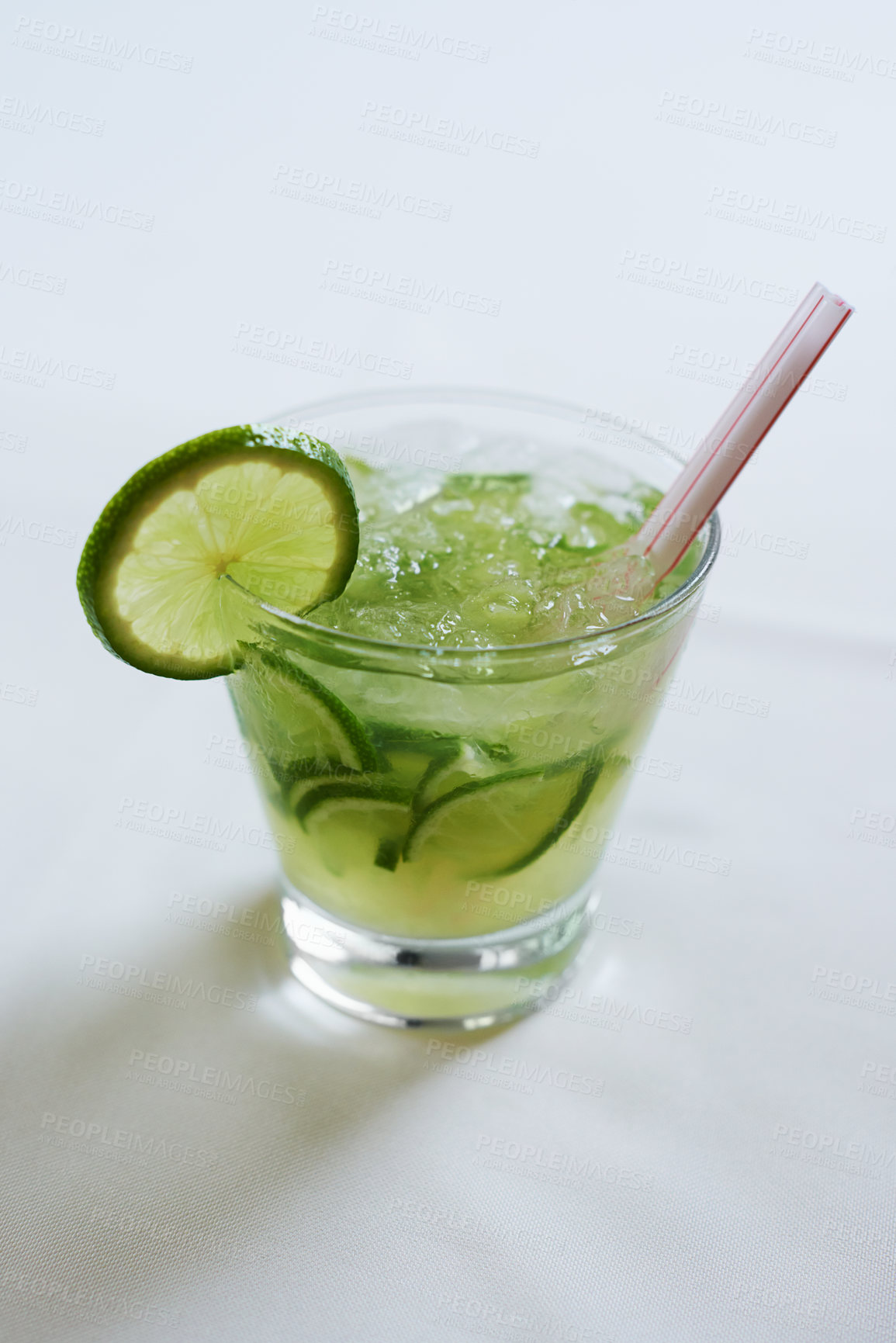 Buy stock photo Cocktail, alcohol and glass with lime for mojito drink on table for party, club and bar. Mockup, background and closeup of mocktail, beverage and liquid with fruit, ice and liquor for celebration