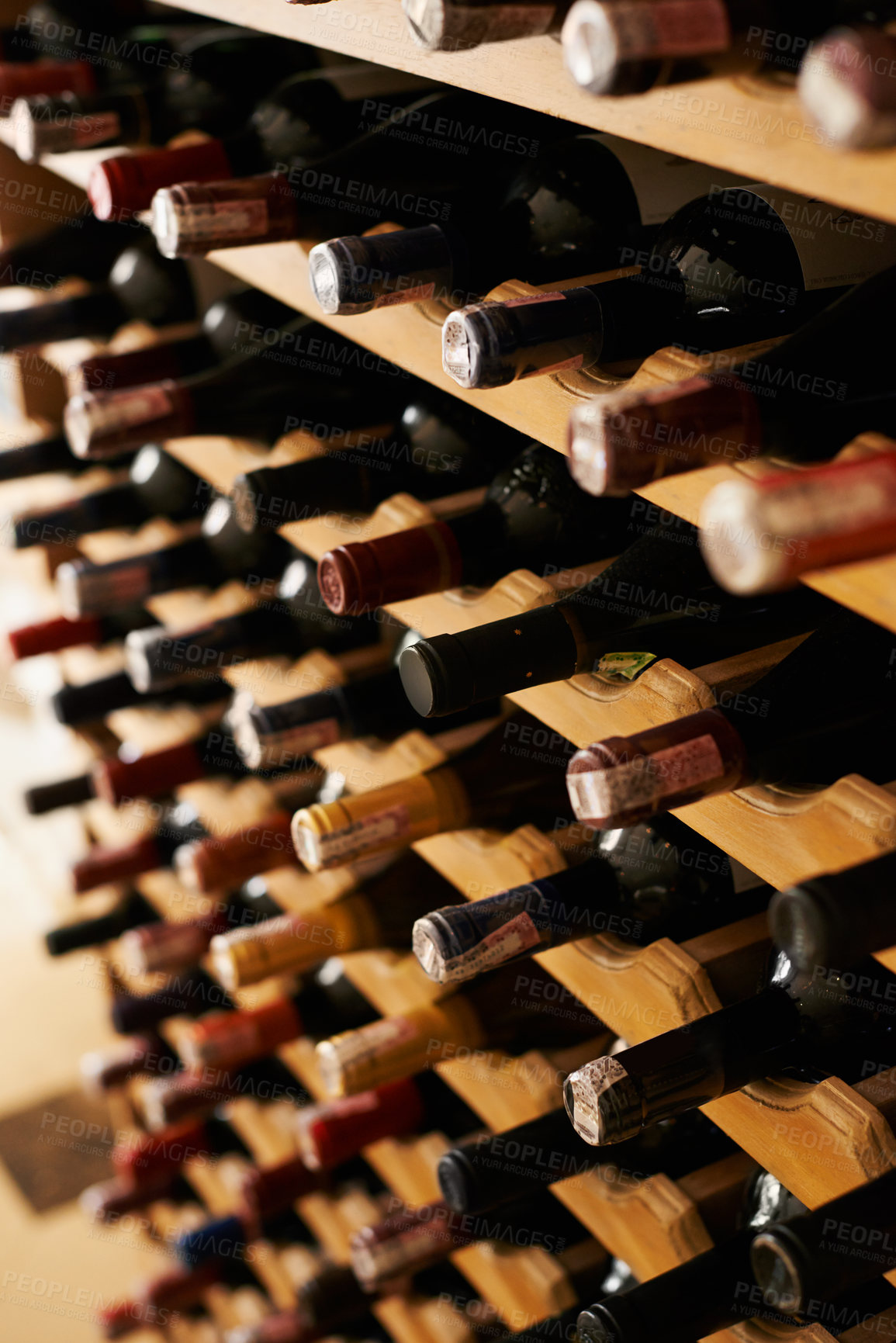 Buy stock photo A collection of wine bottles in a cellar