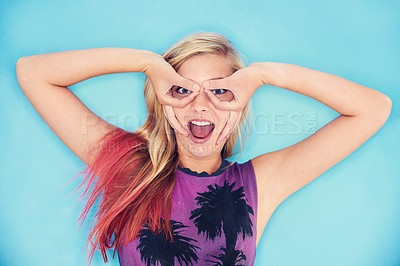 Buy stock photo Young woman, funny portrait and rock fashion in studio mock up and punk style for gen z culture. California, student and excited face with silly okay gesture and trendy clothes by blue background