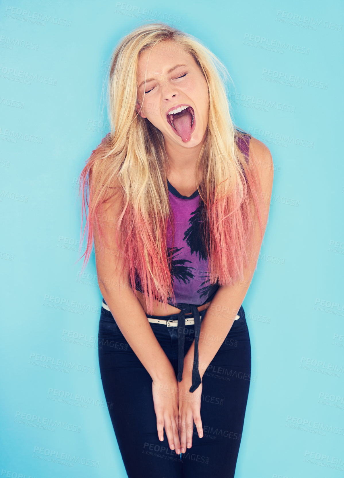 Buy stock photo Crazy, studio and gen z fashion for unique girl on blue background, comic and outfit for youth. Punk, fun and female person with long dyed hair, funny face and cool as  model for summer clothes