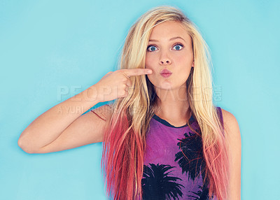 Buy stock photo Cropped shot of an attractive and trendy young woman pointing at her lips