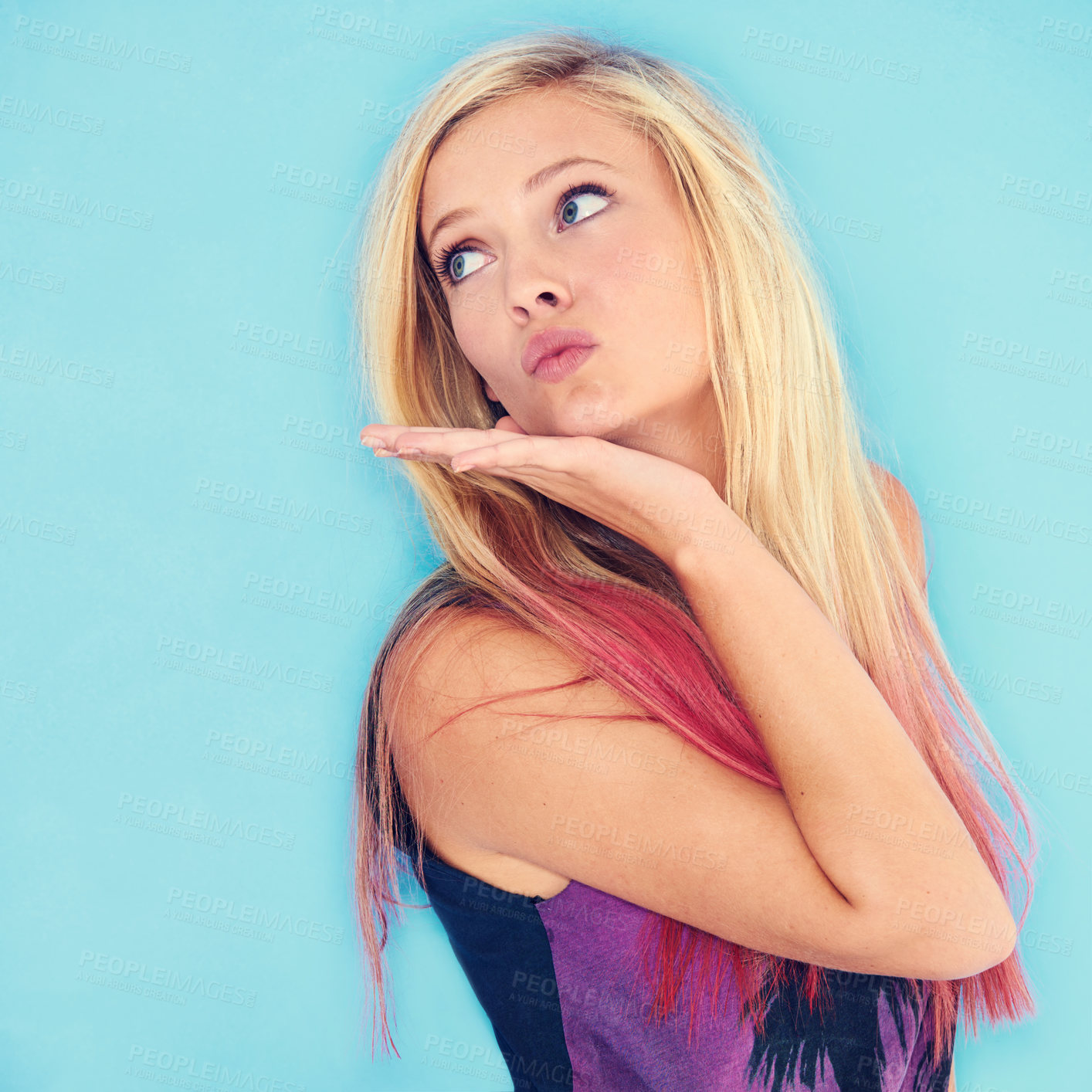 Buy stock photo Cropped shot of a trendy young woman blowing a kiss