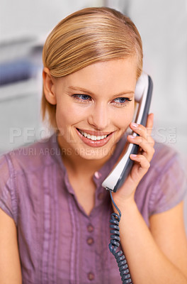 Buy stock photo Shot of a beautiful young woman using a phone at her desk