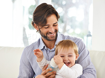 Buy stock photo Father, baby and laughing while playing, feeding and love at home for child development and growth. Dad, parent and infant for fun, cheerful and family at house after work and nutrition and laugh