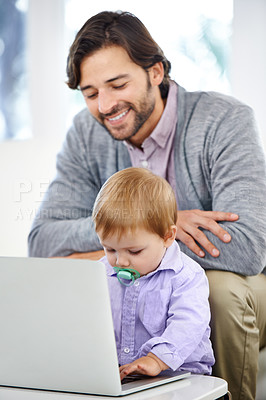 Buy stock photo A handsome young man with his baby boy