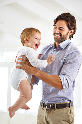 Buy stock photo Dad, baby and laughing while playing, bonding and love at home for child development and growth. Father, parent and infant for fun, cheerful and family at house after work and getting kid to sleep