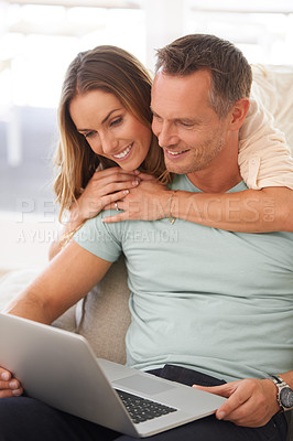 Buy stock photo Computer, sofa and happy couple with home internet for online planning, website review or check application together. Hug, love and affection of mature woman, partner or people on laptop technology
