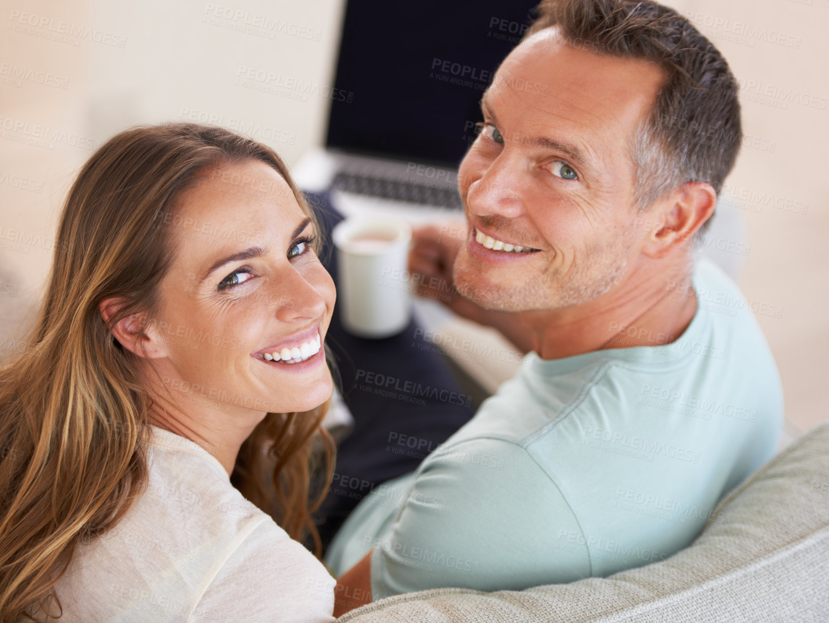 Buy stock photo Happy couple, smile and portrait with love on couch, romantic and commitment with care in marriage. Man, woman and excited face for bonding in apartment, weekend and coffee in home for online movies