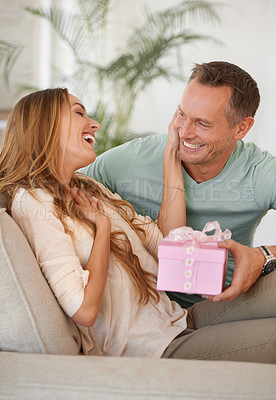 Buy stock photo Man, present and surprise for woman with gratitude, happy people with love and trust at home. Anniversary, birthday or event, couple with secret gift box with thank you for celebration and romance
