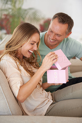 Buy stock photo Woman opening present, man and happiness with surprise for birthday or anniversary, love and support with romance. Couple in marriage, unboxing package and gift giving for token of appreciation