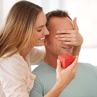 Buy stock photo Wife surprise or gift for husband in home and eyes closed for happy couple to celebrate love on couch. Woman, care and giving a present to man, romantic and bonding together on sofa on anniversary