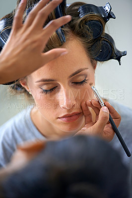 Buy stock photo Makeup, hair curlers and face of woman in salon with professional stylist for makeover.  Cosmetics, eyeliner or curling for haircare and celebrity or actress getting ready backstage behind the scenes