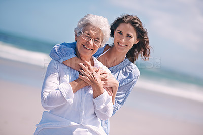 Buy stock photo Portrait, young woman and hug her senior mother or smile or on the beach and together outdoors. Senior citizen, happy family and embracing with adult daughter or peace or freedom at sea for travel 