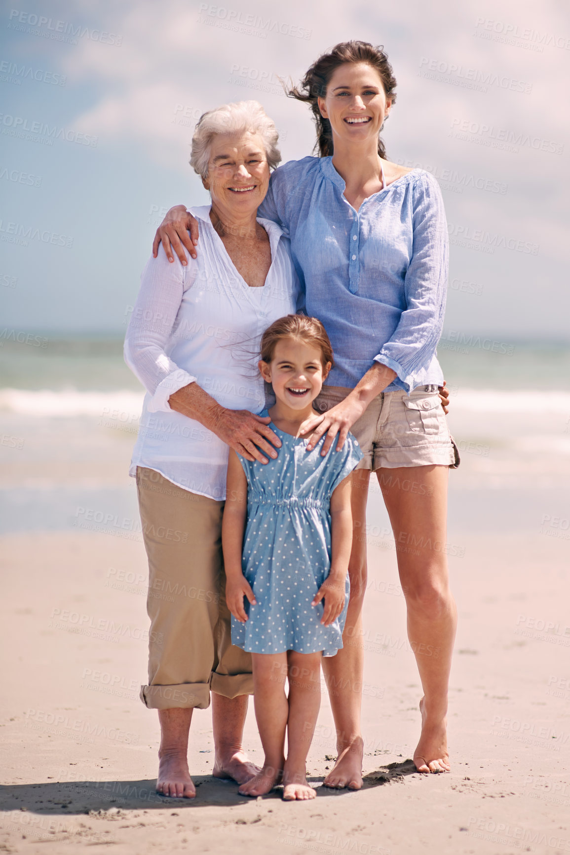 Buy stock photo Portrait of a woman with her daughter and mother at the beach