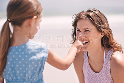 Buy stock photo Happy mother, child and sunscreen on nose at beach for summer holiday, vacation or travel. Mom, kid and apply sunblock cream outdoor for protection, health and skincare of family laughing together